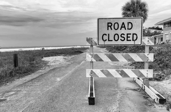 Road closed sign with bad weather