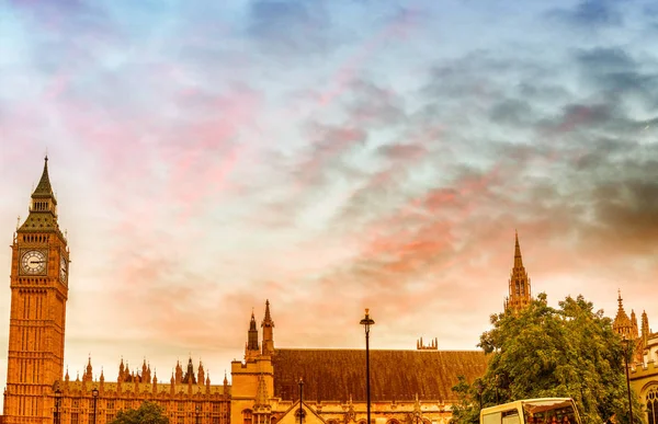 Westminsterský palác a červené autobusy, panoramatický pohled při západu slunce - Lon — Stock fotografie