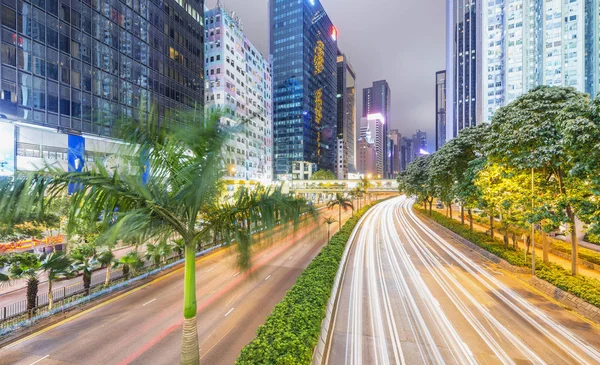 HONG KONG - APRIL 2014: City skyscrapers and road car light trai — Stock Photo, Image