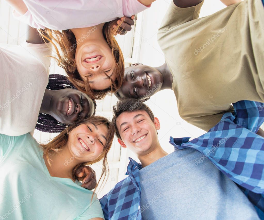 Group of multi ethnic friends bonding and having fun outdoors, u