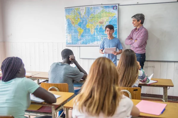 Lärare med en grupp elever i klassrummet med ung pojke — Stockfoto