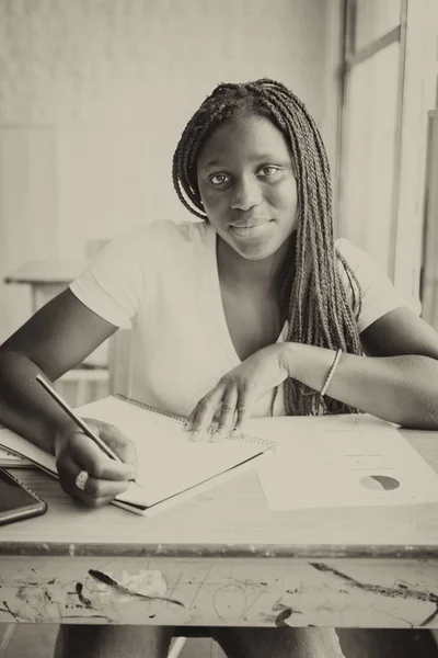 彼女の教室の机の上のノートでアフロ ・ アメリカ学校の女の子 — ストック写真