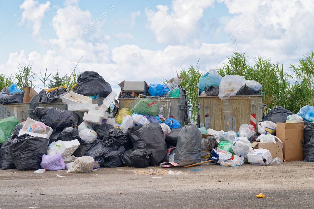 Big rubbish dump near the road. Disposal, deterioration and pollution concept.