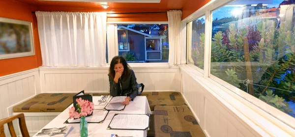 Woman in a restaurant thinking what to order.