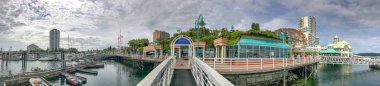 NANAIMO, CANADA - AUGUST 14, 2017: City Harbour with tourists. Nanaimo is a famous tourist destination in Vancouver Island. clipart