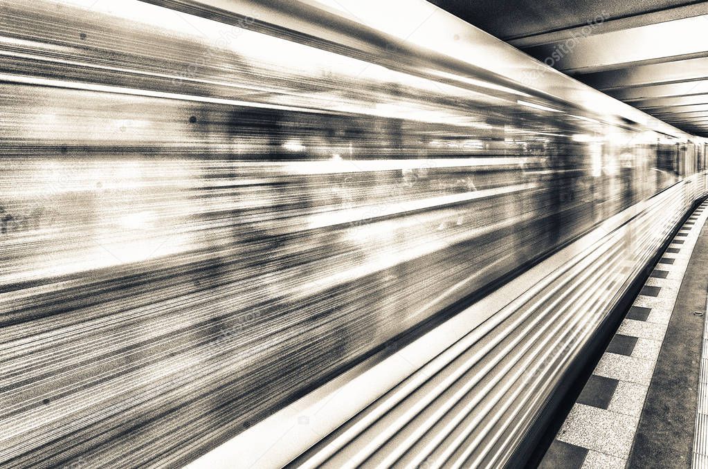 Yellow subway train speeding up on a city station. Business and transportation concept.