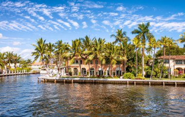 FORT LAUDERDALE, FL - FEBRUARY 29, 2016: Beautiful homes along city canals. Fort Lauderdale is a famous tourist attraction in Florida. clipart