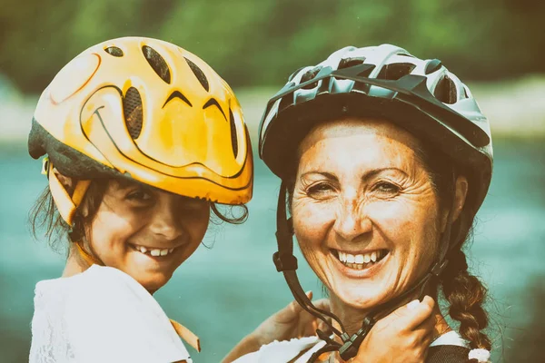 Meisje met moeder dragen fiets helm — Stockfoto