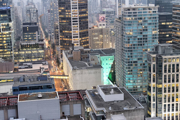 VANCOUVER, CANADA - AUGUST 8, 2017: Aerial view of Downtown buildings at night. Vancouver attracts 10 million people annually.