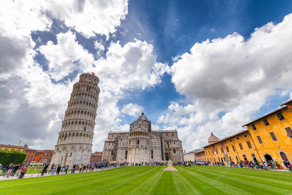 PISA, ITALY - APRIL 30, 2018: Tourists enjoy Square of Miracles. Pisa attracts 5 million tourists annually.