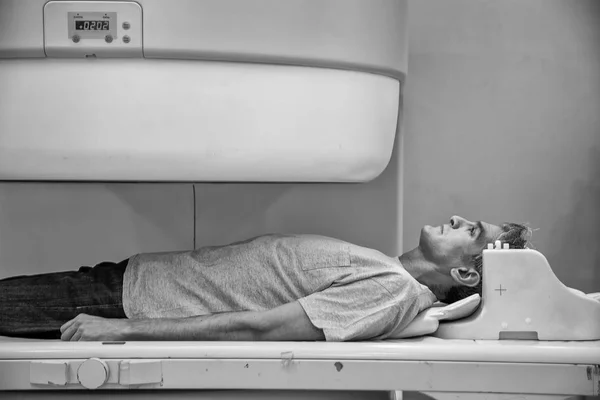 Man at hospital undergoing MRI.