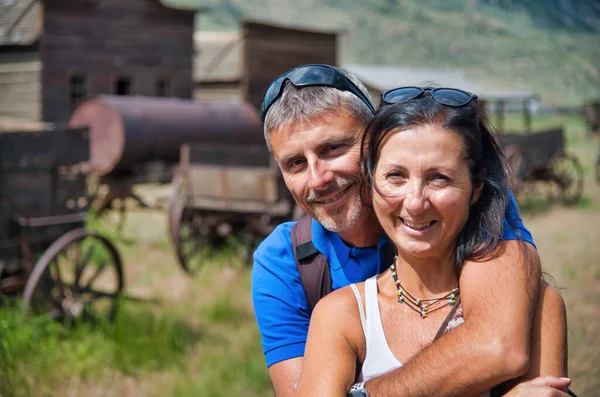 Happy couple visit ancient western town in the summer