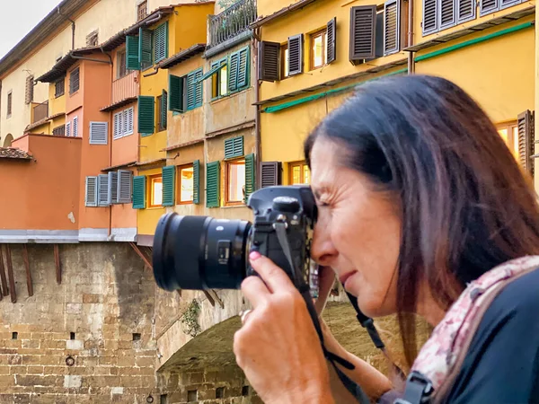 Fotografo donna che scatta foto del Ponte Vecchio e del polmone di Firenze — Foto Stock