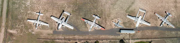 Aerial top downward view of symmetric parked light old aircrafts — Stock Photo, Image