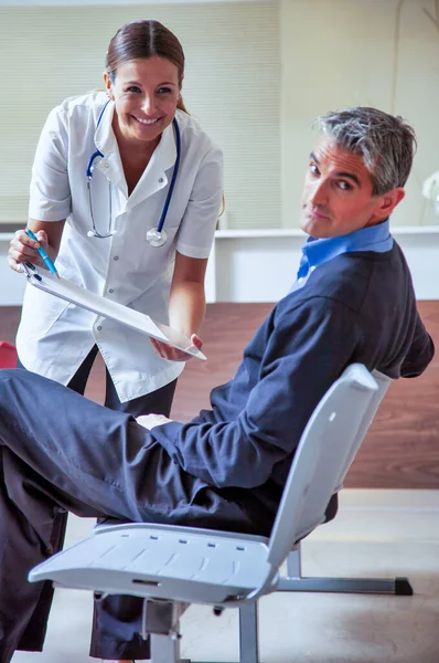 Female Doctor Asking Patient Fill Paper Hospital — Stock Photo, Image