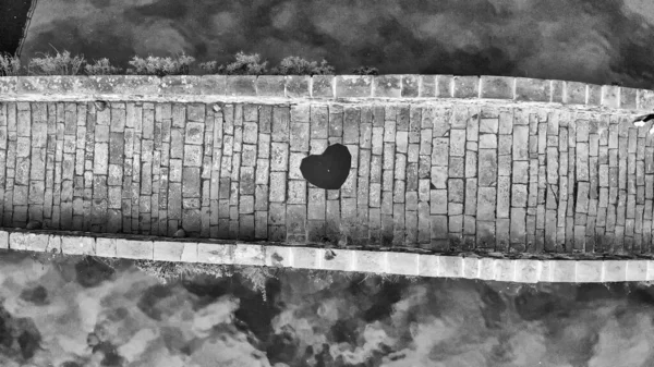 Aerial overhead view of Devils Bridge, Lucca. Red heart shape um