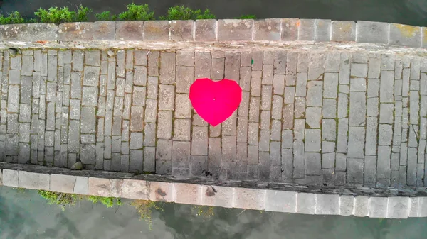 Aerial overhead view of Devils Bridge, Lucca. Red heart shape um