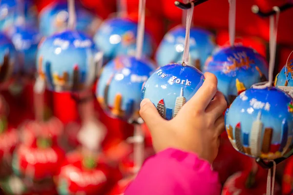 Young girl hand touching Christmas Balls in New York City — Stock Photo, Image
