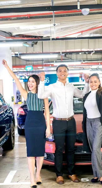 Tres felices amigos asiáticos sonriendo después de comprar un nuevo coche deportivo —  Fotos de Stock