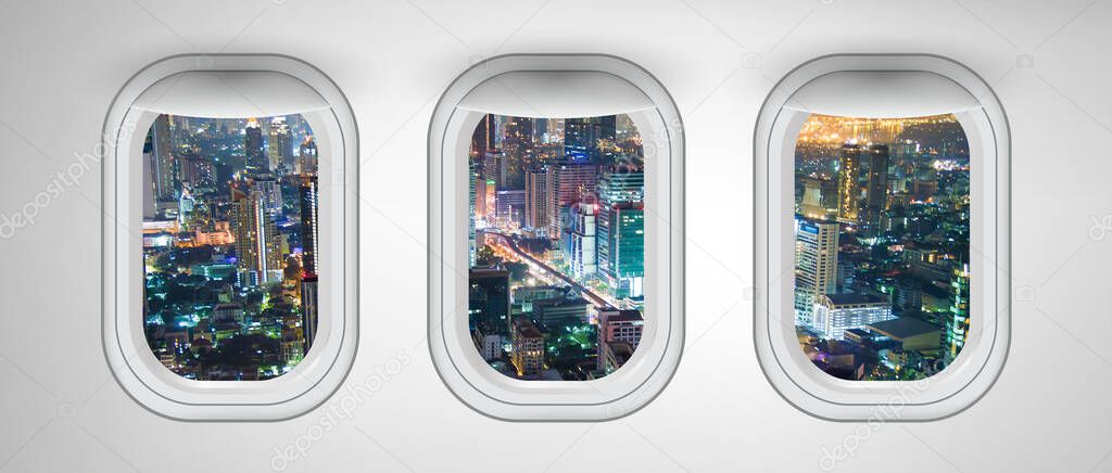 Airplane windows with Bangkok night skyline view, Thailand. Travel and holiday abstract concept.