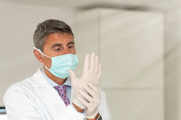 在验尸官时代 自信的医生戴着面具和手套出现在医疗演播室 — 图库照片