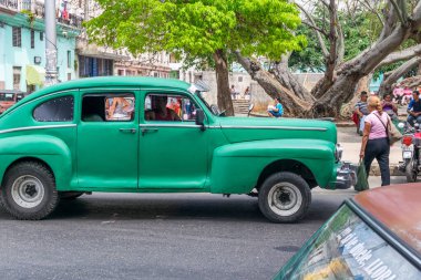 HAVANA, CUBA - 4 Nisan 2017: Amerikan yeşil klasik araba Havana Küba yolunda ilerliyor.