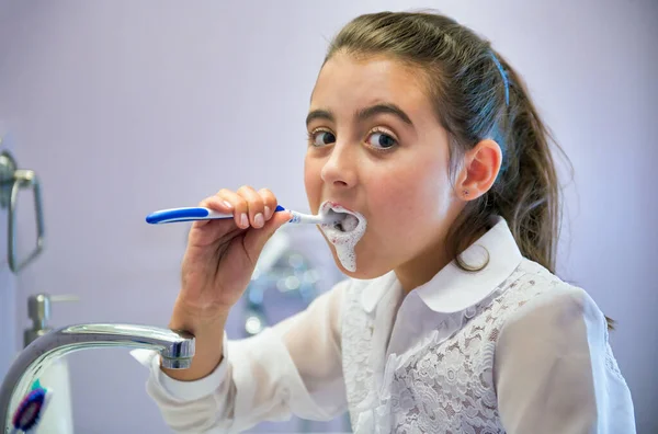 Young girl and dental cleaning. Washing teeth at home.