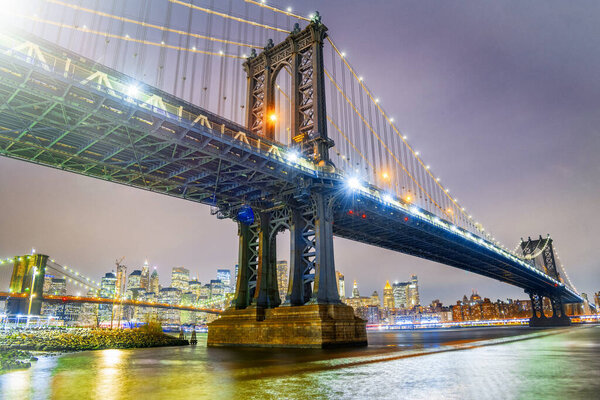 Amazing night view of Manhattan and Brooklyn Bridge at night, winter season, New York City lights