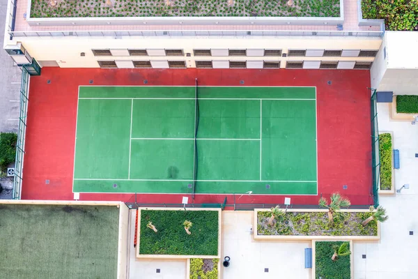 Downward aerial view of tennis court.
