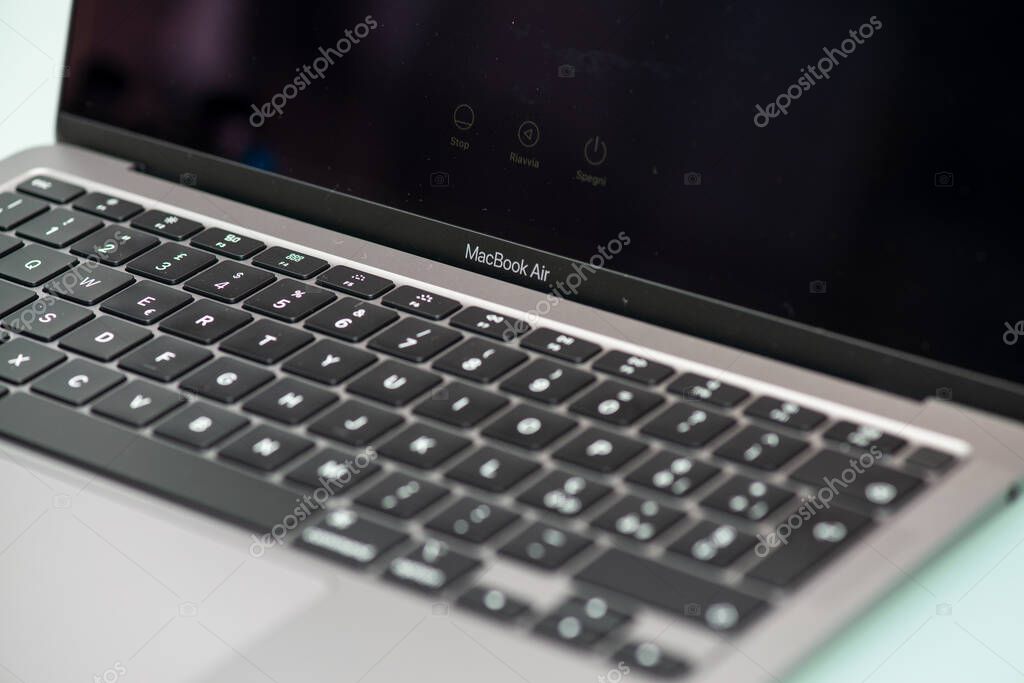 PISA, ITALY - MAY 15, 2020: Studio shot of new Apple Macbook Air 13 inches 2020. Keyboard view, isolate on glass background. Illustrative editorial content.