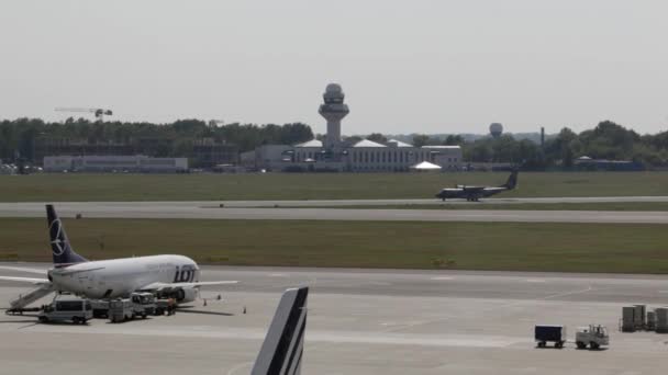 Commercial plane prepare to take off at airport, takeoff aircraft with Chopin Airport. Warsaw Airport, Plane stands in airport, territory near control office, — Stock Video