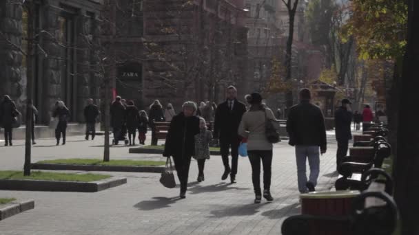 Kalabalık alışveriş caddesi üzerinde yürüyen insanlar. İnsanlar şehir sokakta yürürken, insanlar. Sonbahar günü güneşli bir gün. Yerli halk ve turistler Kuyv ana cadde boyunca yürümek — Stok video