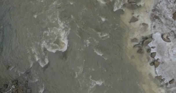 Mountain river från en fågels eye view, snöiga vintern. Flyger över floden i bergen. Vinter bergslandskap från ett fågelperspektiv. Snabb mountain river i snön. — Stockvideo