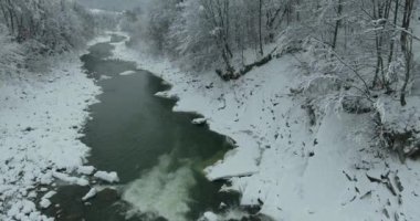 Kış dağlarda. Uçuş kış manzara Dağların üzerinden. Karlı kış dağlarda. Bulutlu kış günü. Dağ manzarası üzerinden bir kuş bakışı.