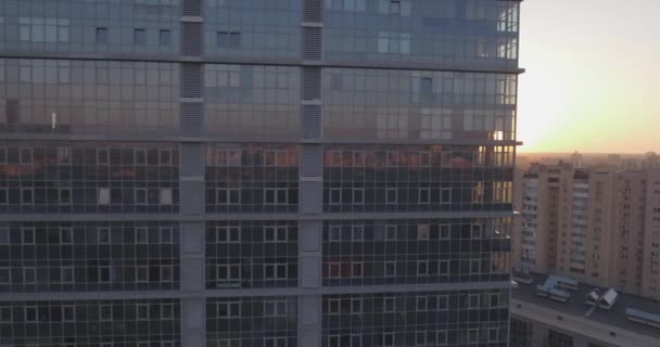 Indagine aerea la città di Kiev-riva sinistra, un edificio di vetro all'alba. 27. Settembre 2017. nelle finestre dell'edificio per uffici un riflesso dell'alba da oltre l'orizzonte. paesaggio urbano . — Video Stock