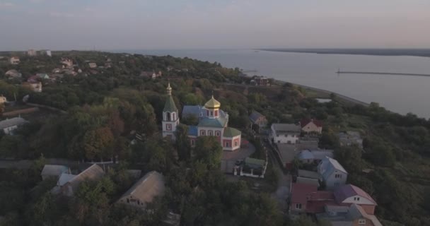 Inspección aérea. ciudad de Vyshgorod-iglesia en la montaña cerca del río Dniéper. amanecer en el río. una hermosa iglesia al amanecer. una pequeña iglesia se encuentra en la montaña al amanecer del día . — Vídeos de Stock