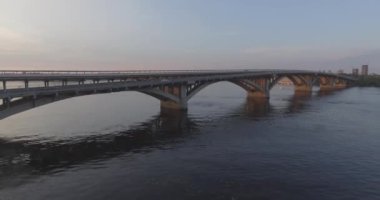 Hava. Ukrayna şehir Kiev. Metro Dnieper İstasyonu'na varış. 2017.06.09. metro Dnieper Nehri Köprüsü. Yaz alacakaranlık, köprü Idol Dnepr metro Köprüsü yukarıdaki arabaları.