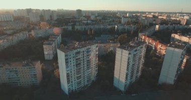 Hava, cadde ve gündoğumu, yüksek binalar. Yaz sabah cityscape üzerinden bir kuş bakışı. Metropol üzerinde uçuş. Güneşli sabah, mavi gökyüzü. Bir sürü yeşil ağaç sokaklarda.