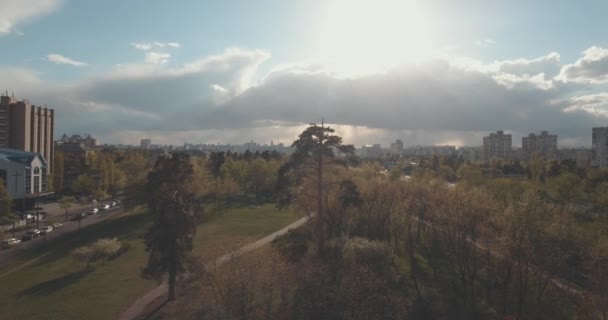 夕暮れ時 空中都市の住宅街 都市の景観 公園や広場の高さから 夏の夜 集合住宅 緑の木々 ドニエプル川 車の軌跡 公園でくつろぐ人々 — ストック動画