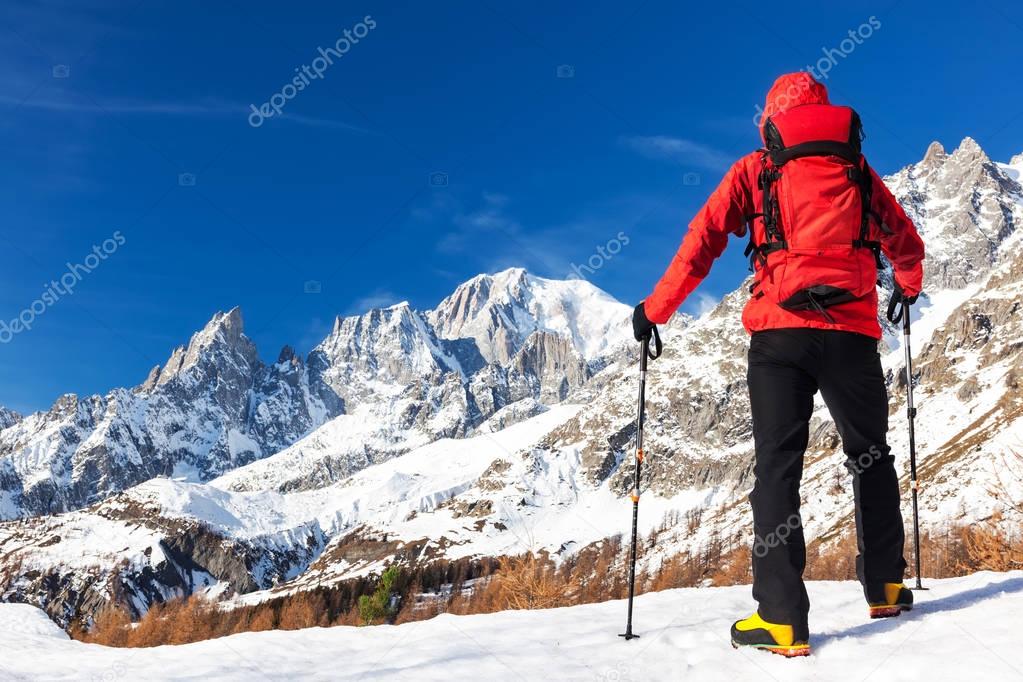 Hiker takes a rest looking at Mont Blanc