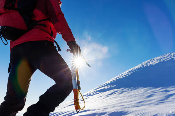 climber at top of snowy peak 