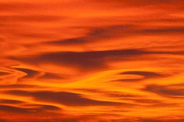 Beautiful sunset sky with lenticular clouds.