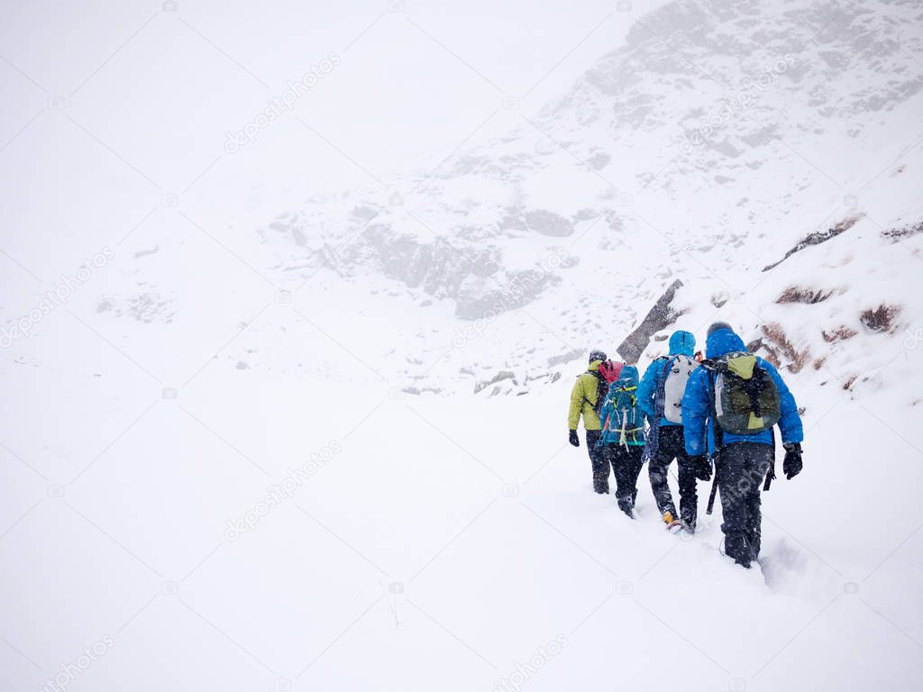 Mountaineers team walks in fresh snow during a winter expedition