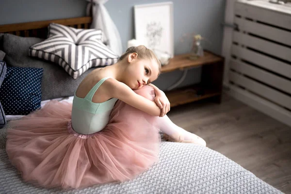 ballerina sitting on bed