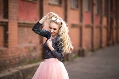 Güzel bir kız cadde boyunca yürüyor.