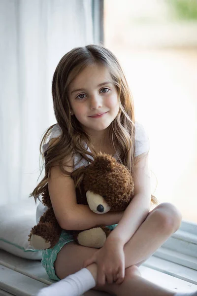 Portrait of a beautiful girl with a brown toy bear — Stock Photo, Image