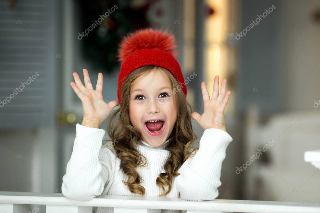 Smiling funny girl in red hat. Christmas concept.