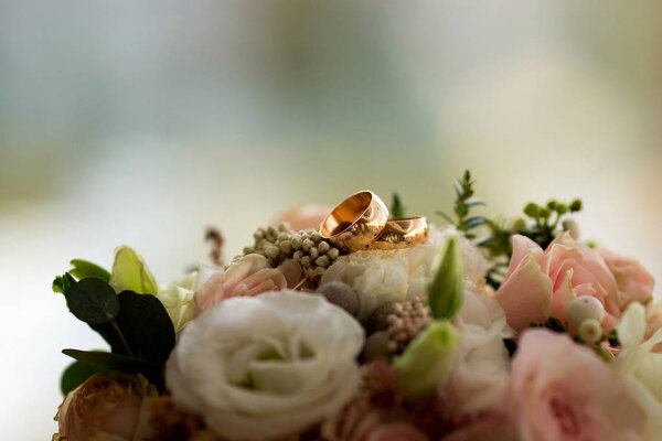 Wedding rings on the bouquet. morning bride