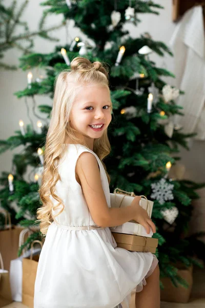Joyeux mignon petite fille souriante avec boîte cadeau de Noël. Joyeux Noël et Joyeuses Fêtes . — Photo