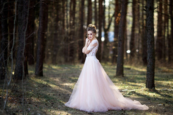 Beautiful bride in white dress. bride is walking in the woods